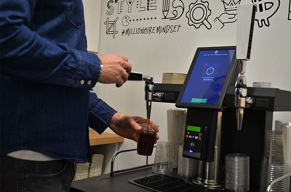KVM Automated Coffee in use — customer pouring craft cold brew from self-service tap system